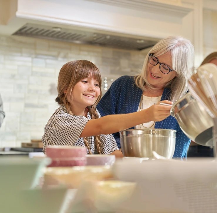 Child and adult at home baking in the kitchen